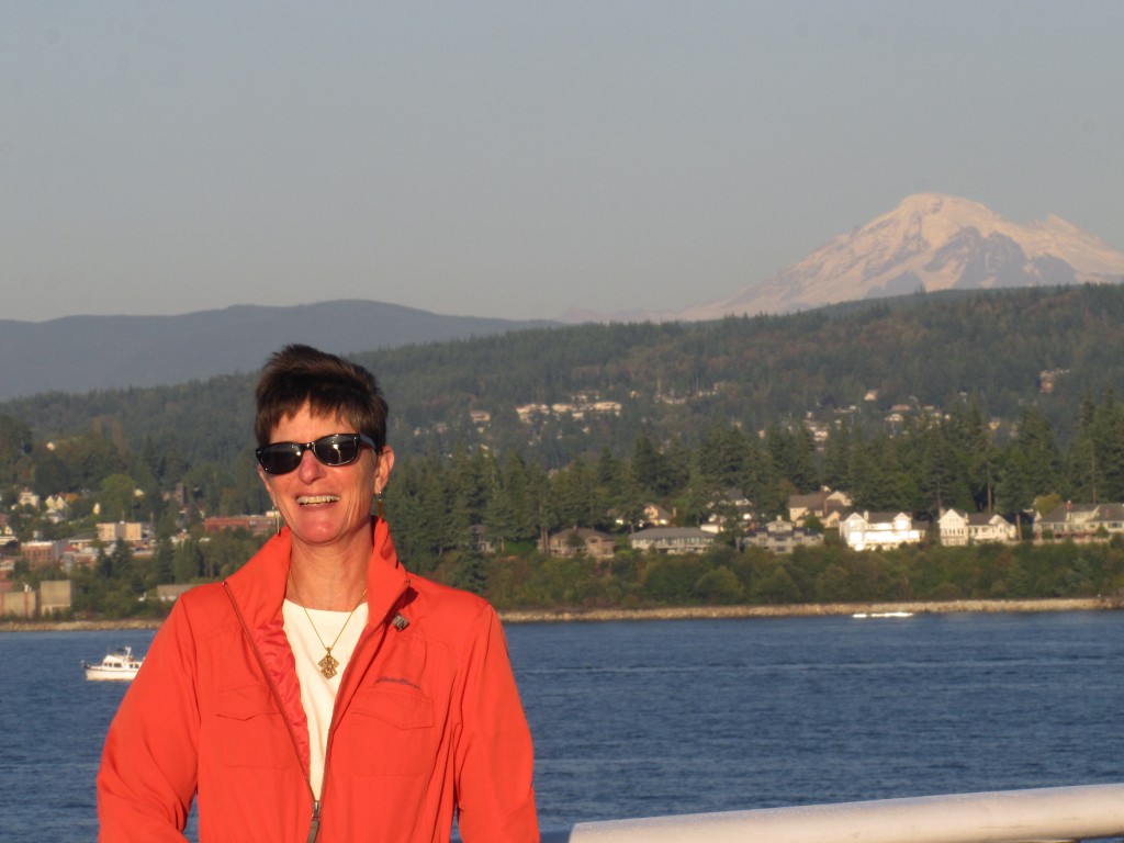 After boarding, the vessel left late afternoon from Bellingham. Susan on the after deck with Mt. Baker in the back ground.